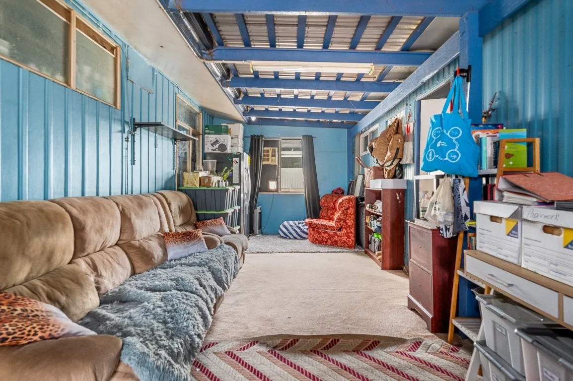 Before photo of a cluttered blue room before virtual staging and presentation improvements.