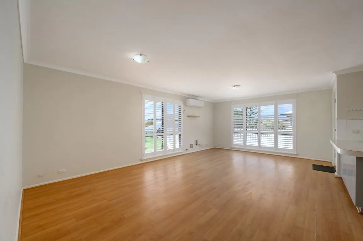 Before photo of an empty open-plan living area in a home before virtual staging.