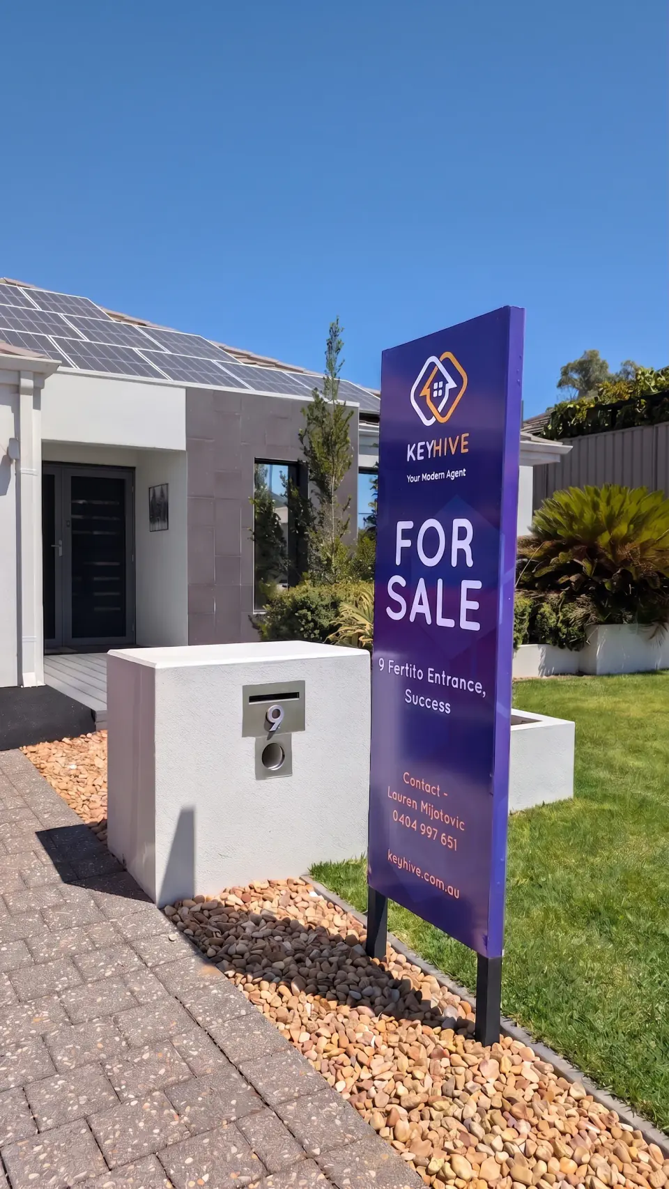 A KeyHive For Sale signboard outside a modern Perth home with solar panels